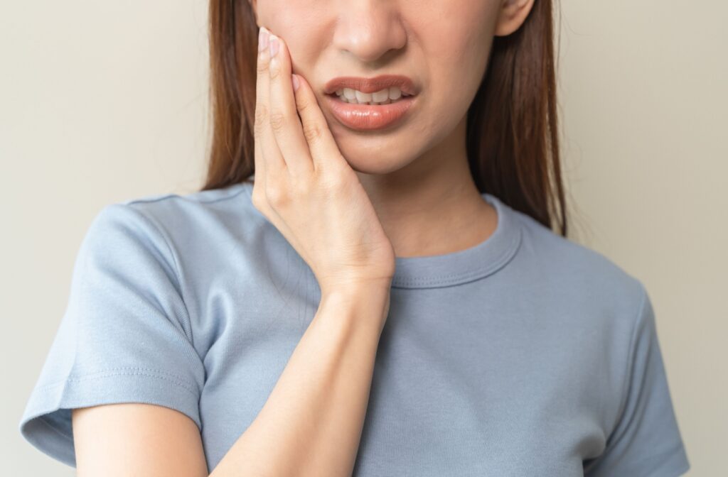 A person holding their jaw from pain